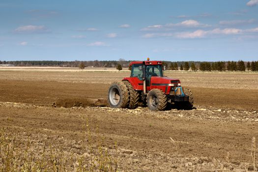 tractor cultivated fields in early spring