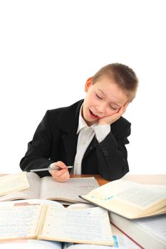 bored and tired schoolboy on the table