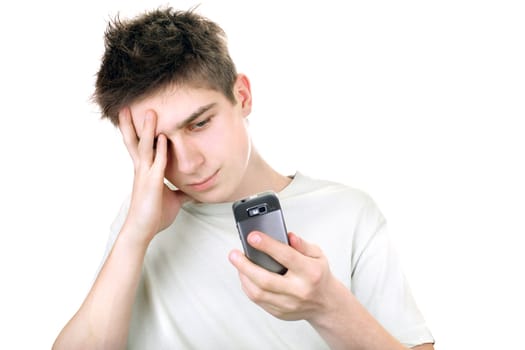 discontented young man looking on the mobile phone. isolated on the white