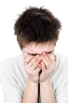 sorrowful young man crying with hidden face on the white background