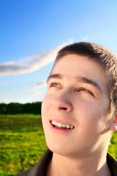 happy young man portrait in the summer field