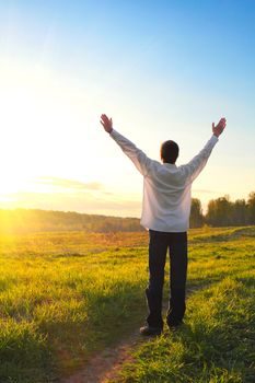 happy man silhouette on sunset background