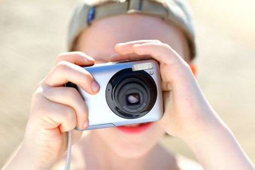 small boy with photocamera outdoor