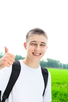 happy teenager portrait with thumb up in the summer field