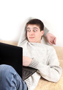 surprised young man with notebook in home interior