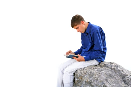 teenager sitting with a book on the stone. isolated on the white