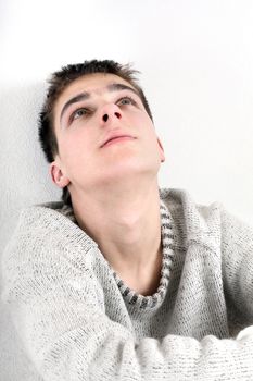 sad young man portrait next to the wall