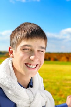 happy and smiling teenager portrait in the autumn field