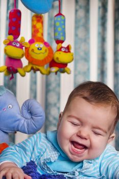 View of a newborn baby with a stuffed toy.