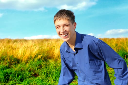 happy and smiling teenager running in the field