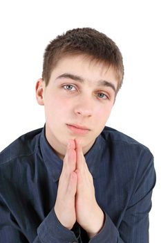 Teenager praying isolated on the white background
