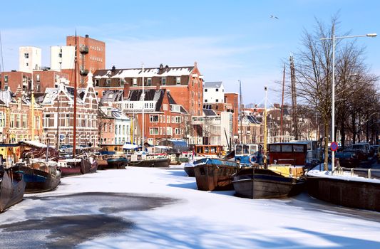 view on white channel covered with snow in Groningen, Netherlands