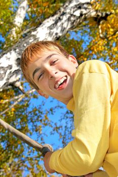 Young and happy teenager jumping on the bungee in the autumn forest