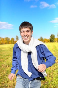 happy teenager running on the autumn field