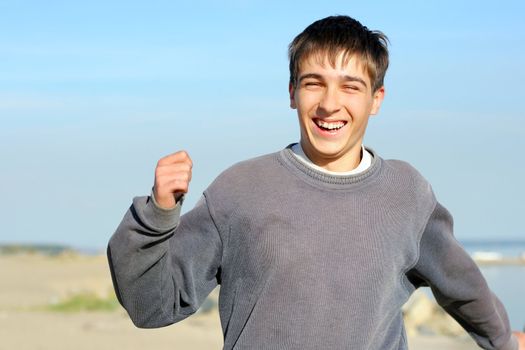 happy teenager running on the empty beach