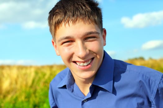 happy and smiling teenager portrait in the field