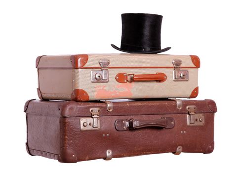 old suitcases with black hat