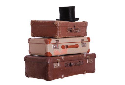 old hat on top of stacked suitcases