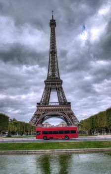 dark scene of Eiffel tower in Paris, France and red bus