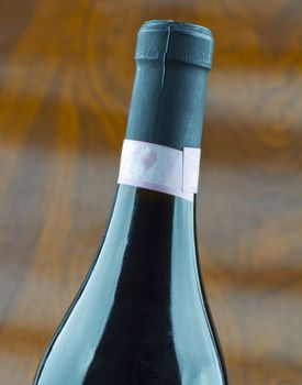 Wine bottle of red wine over wooden background