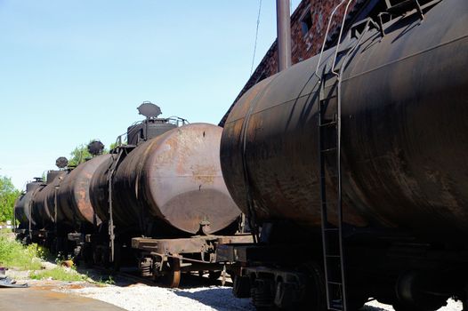 Old railway tanks are on unloading of black oil