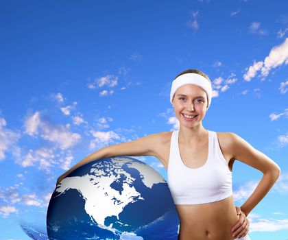 Portrait of a young woman doing sport with a bottle of pure water