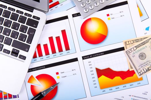 Financial paper charts and graphs on the table