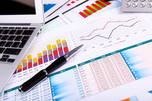 Financial paper charts and graphs on the table