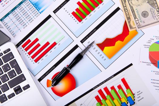 Financial paper charts and graphs on the table