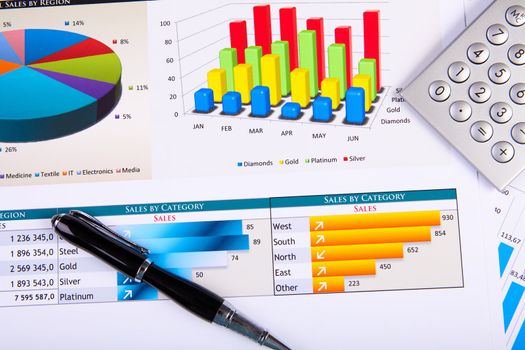 Financial paper charts and graphs on the table