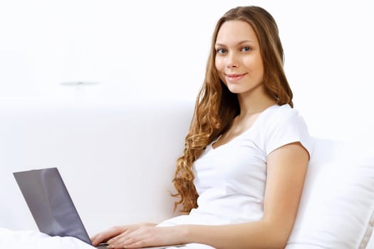 Portrait of young woman sitting with a notebook