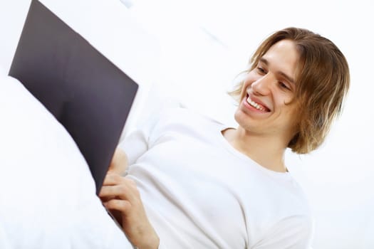 Portrait of a young man with notebook