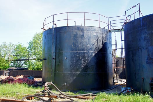 The tank for black oil on a background of the sky