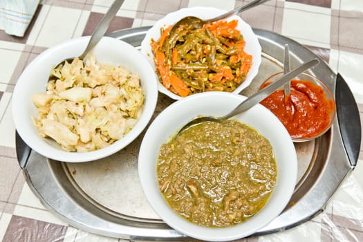 Different kinds of traditinal Ethiopian wot (stew) served in a bowl.