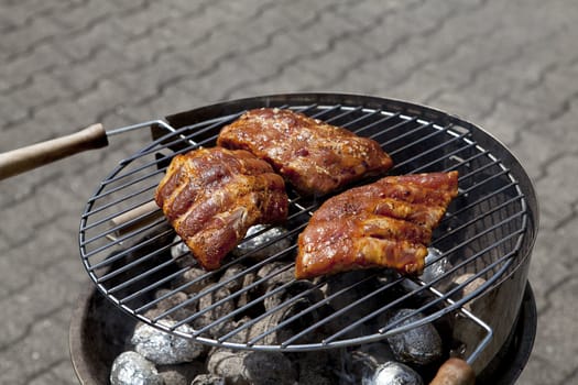 barbecue grill wiht meat and vegetables outside in summer