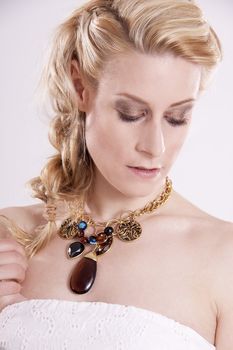 portrait of a young beautiful woman with jewellery isolated