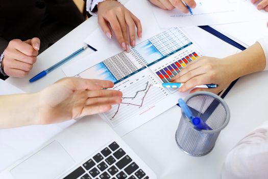 Financial paper charts and graphs on the table