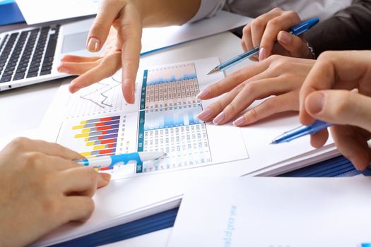 Financial paper charts and graphs on the table