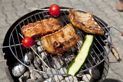 barbecue grill wiht meat and vegetables outside in summer