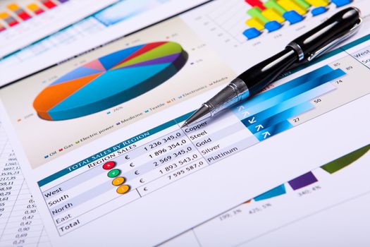 Financial paper charts and graphs on the table