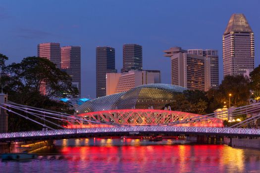 Singapore skyline. Singapore river and Cavenagh Bridge in the evening