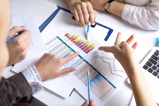 Financial paper charts and graphs on the table