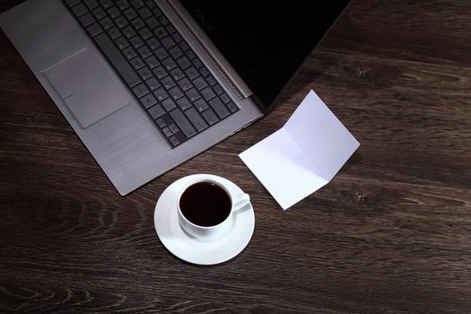 White cup with black coffee at business workplace