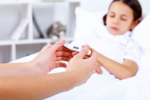 Little girl with illness at bed at home