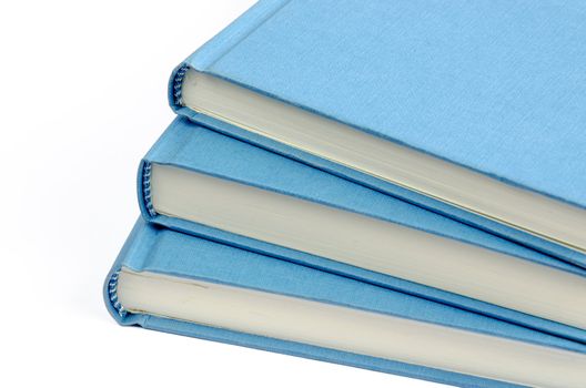 A fan of three blue books on a white background