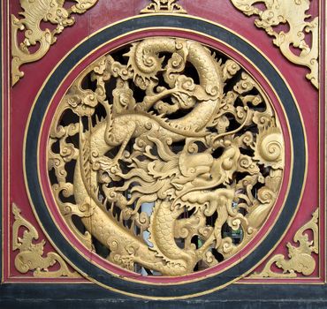 Wood Carving Chinese Dragon on Outside Temple Door with Bats Motif