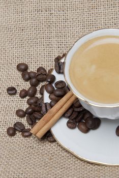 Still life about coffee with a delicious  espresso and some coffee beans and cinnamon.