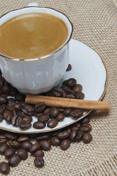 Still life about coffee with a delicious  espresso and some coffee beans and cinnamon.