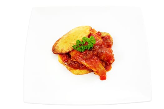 dish of hake with tomato sauce on a bed of potatoes cut off and isolated