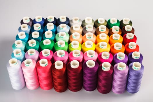 Sewing threads as a multicolored background closeup